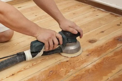 mechanical sander stripping paint from wood